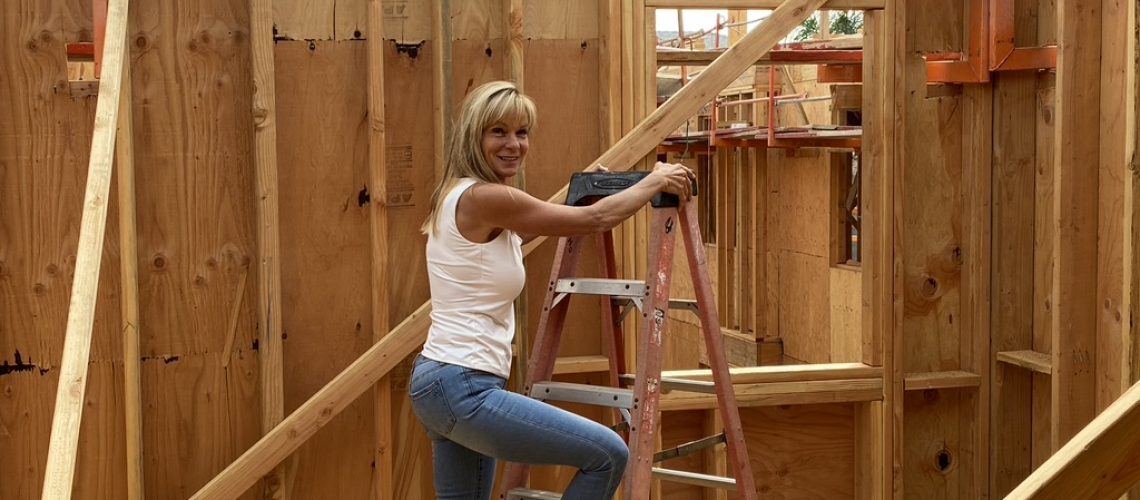 dawn matze woman builder on ladder renovation